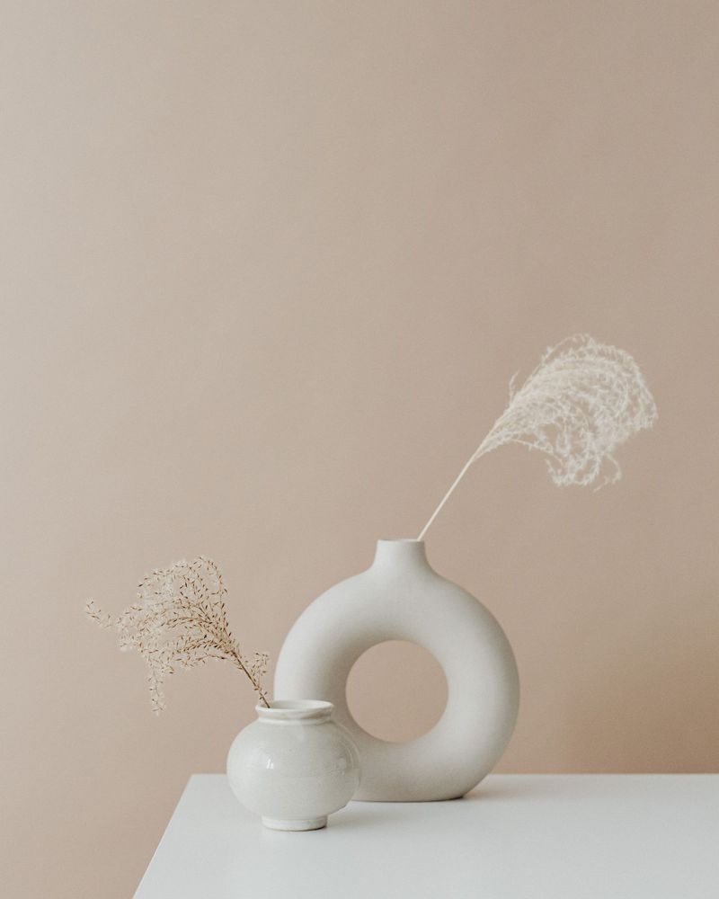 A sculptural ceramic vase with dried pampas grass